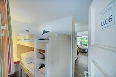 a small room with bunk beds in a room at IMMOGROOM - 2 Rooms - Renovated - Pool - AC - Parking - Garden in Cannes