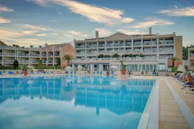 a hotel with a swimming pool in front of a building at IMMOGROOM - 2 Rooms - Renovated - Pool - AC - Parking - Garden in Cannes