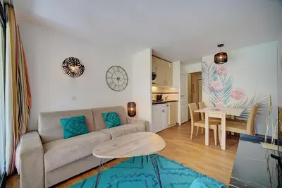 a living room with a couch and a table at IMMOGROOM - 2 Rooms - Renovated - Pool - AC - Parking - Garden in Cannes
