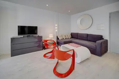 a living room with a couch and a table at Lumineux Studio TERRASSE, Rouaze-MARTINEZ CARLTON A0B132 in Cannes