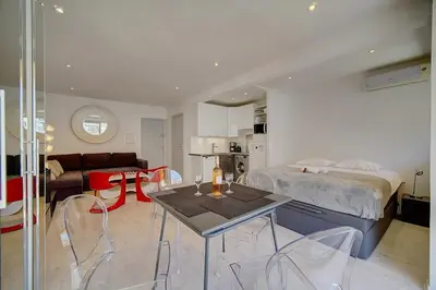 a bedroom with a bed and a table and chairs at Lumineux Studio TERRASSE, Rouaze-MARTINEZ CARLTON A0B132 in Cannes