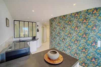 a kitchen with a wall with a floral wallpaper at Chic 2 chambres vue PORT, FELIX FAURE-COEUR DE CANNES A2B218 in Cannes