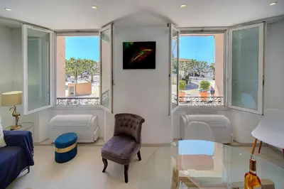 a living room with a glass table and windows at Chic 2 chambres vue PORT, FELIX FAURE-COEUR DE CANNES A2B218 in Cannes