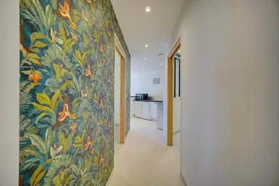 a hallway with a wall with a colorful wallpaper at Chic 2 chambres vue PORT, FELIX FAURE-COEUR DE CANNES A2B218 in Cannes