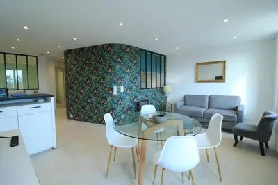 a living room with a glass table and white chairs at Chic 2 chambres vue PORT, FELIX FAURE-COEUR DE CANNES A2B218 in Cannes