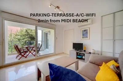 a living room with a couch and a table at Moderne 2 pièces TERRASSE PARKING, Clémenceau A1B230 in Cannes