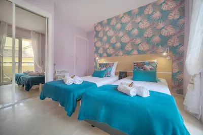 a bedroom with two beds with blue sheets and a wall at Duplex 2 chambres TERRASSE, MEYNADIER- FORVILLE A2B103 in Cannes