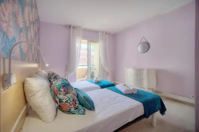 a bedroom with a bed with pillows and a window at Duplex 2 chambres TERRASSE, MEYNADIER- FORVILLE A2B103 in Cannes