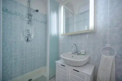 a white bathroom with a sink and a shower at Duplex 2 chambres TERRASSE, MEYNADIER- FORVILLE A2B103 in Cannes