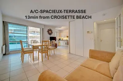 a living room with a couch and a table at Spacieux 2 chambres TERRASSE, CANNES CENTRE A2B067 in Cannes