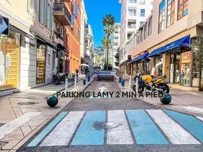 a street with a motorcycle parked on a sidewalk at Magnifique 2 chambres VERANDA, CANNES CENTRE-BANANE A2B088 in Cannes