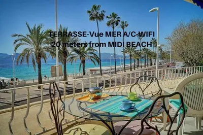 a table and chairs on a balcony overlooking the beach at 2 pièces TERRASSE vue MER- 20 m de la PLAGE A1B120 in Cannes