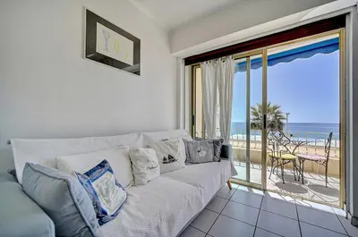 a living room with a couch and a view of the ocean at 2 pièces TERRASSE vue MER- 20 m de la PLAGE A1B120 in Cannes