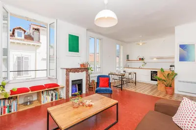 a living room with a table and a fireplace at IMMOGROOM - Bright flat - near shops - CONGRESSBEACHES in Cannes