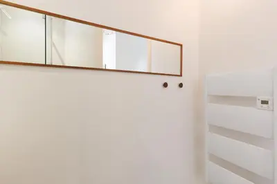 a staircase with a mirror on the wall at IMMOGROOM - Bright flat - near shops - CONGRESSBEACHES in Cannes