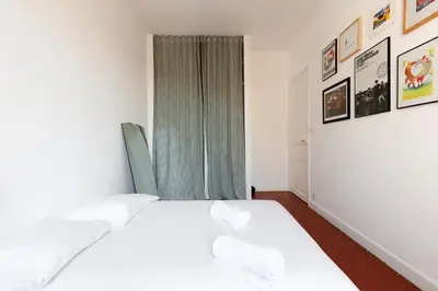 a bedroom with two beds and a window at IMMOGROOM - Bright flat - near shops - CONGRESSBEACHES in Cannes