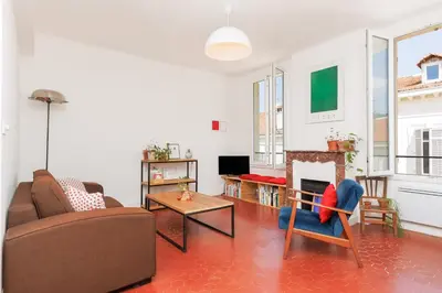 a living room with a couch and a fireplace at IMMOGROOM - Bright flat - near shops - CONGRESSBEACHES in Cannes