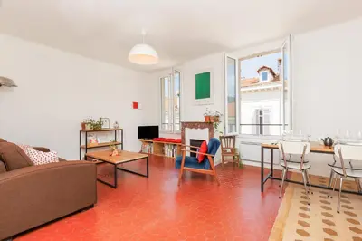 a living room with a couch and a table at IMMOGROOM - Bright flat - near shops - CONGRESSBEACHES in Cannes