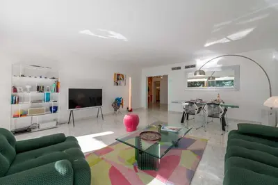 a living room with a couch and a table at 2-Br Luxury Apartment with Sea View and Pool in Cannes