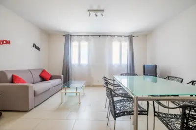a living room with a table and a couch at Bright Apartment In The Heart Of Cannes in Cannes