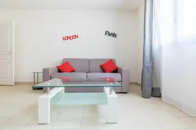 a living room with a couch and a table at Bright Apartment In The Heart Of Cannes in Cannes