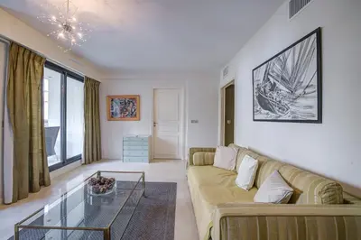 an apartment complex with a pool and buildings at Carlton Riviera Cannes in Cannes