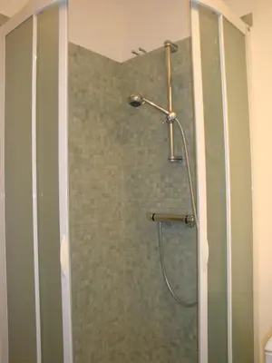 a shower with a glass door in a bathroom at les terrasses du Suquet in Cannes