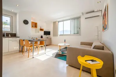 a living room with a couch and a table at 2-Bedroom apartment in Grand Hotel in Cannes