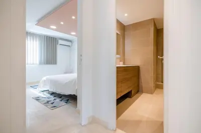 a bedroom with a bed and a bathroom at 2-Bedroom apartment in Grand Hotel in Cannes