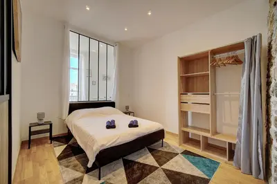 a bedroom with a bed and a large window at Le ART - 500m des plages - Clim - Verrière Côte d'Azur in Cannes
