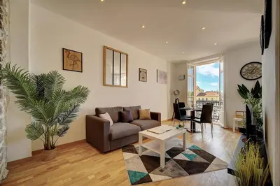 a living room with a couch and a table at Le ART - 500m des plages - Clim - Verrière Côte d'Azur in Cannes
