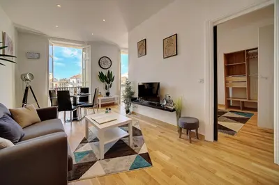 a living room with a couch and a table at Le ART - 500m des plages - Clim - Verrière Côte d'Azur in Cannes