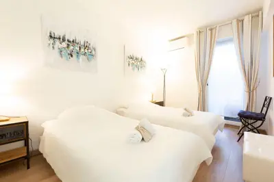 a bedroom with three white beds and a desk at Paradise Cannes Center with Pool and Park VILLA LE LYS in Cannes