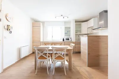 a kitchen and dining room with a table and chairs at Paradise Cannes Center with Pool and Park VILLA LE LYS in Cannes