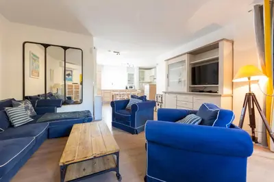 a living room with blue couches and a table at Paradise Cannes Center with Pool and Park VILLA LE LYS in Cannes