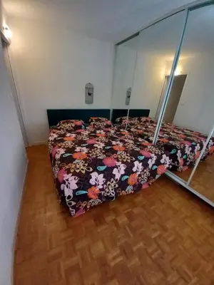 a bedroom with a bed with a comforter on it at Appartement hyper-centre Croisette Cannes in Cannes