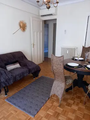 a living room with a table and a couch at Appartement hyper-centre Croisette Cannes in Cannes
