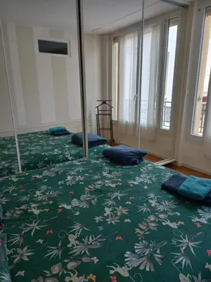 a bedroom with two beds with blue pillows on them at Appartement hyper-centre Croisette Cannes in Cannes