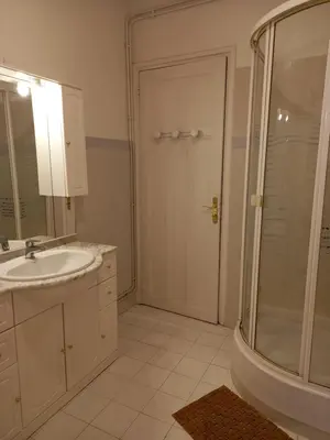 a white bathroom with a shower and a sink at Appartement hyper-centre Croisette Cannes in Cannes