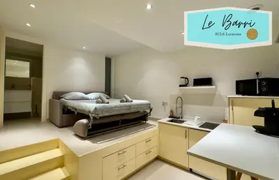 a kitchen with a bed in the middle of a room at Le Barri By SCLS Locations in Cannes