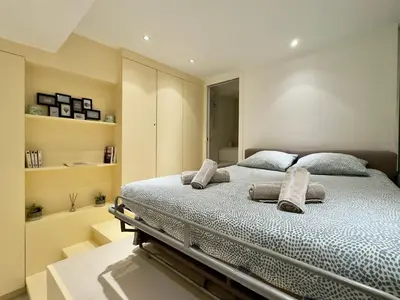 a bedroom with a large bed with pillows on it at Le Barri By SCLS Locations in Cannes