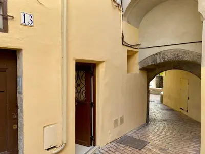 a building with an archway and a door on a street at Le Barri By SCLS Locations in Cannes