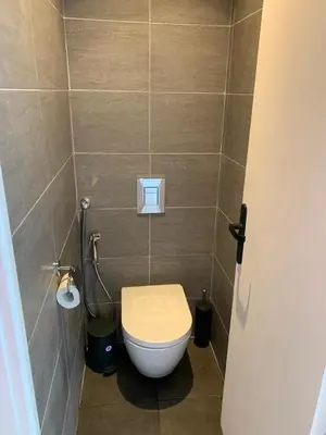 a bathroom with a white toilet in a stall at Beautiful Apartment 2mn walking distance from La Croisette and The Beach in Cannes