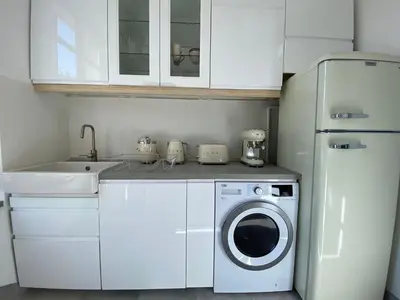 a kitchen with a washing machine and a sink at Beautiful Apartment 2mn walking distance from La Croisette and The Beach in Cannes