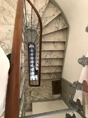 a spiral staircase in a room with a stone wall at Beautiful Apartment 2mn walking distance from La Croisette and The Beach in Cannes