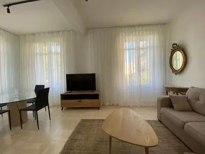 a living room with a couch and a table at Beautiful Apartment 2mn walking distance from La Croisette and The Beach in Cannes