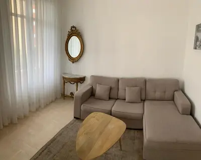 a living room with a couch and a table and a mirror at Beautiful Apartment 2mn walking distance from La Croisette and The Beach in Cannes