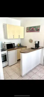 a kitchen with white cabinets and a counter top at Bel Appartement - HYPER CENTRE - 2 pièces in Cannes