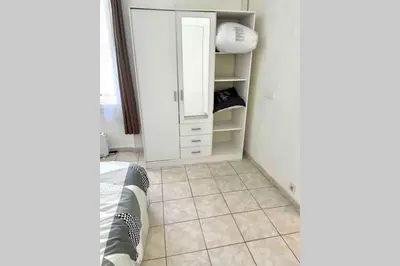 a room with a white cabinet and a tiled floor at Bel Appartement - HYPER CENTRE - 2 pièces in Cannes
