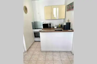 a kitchen with white cabinets and a counter top at Bel Appartement - HYPER CENTRE - 2 pièces in Cannes